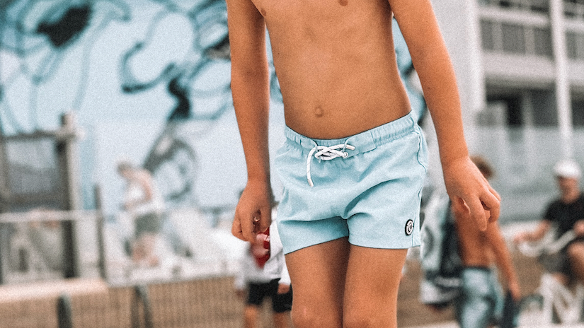 toddler wearing a binkybro swimsuit