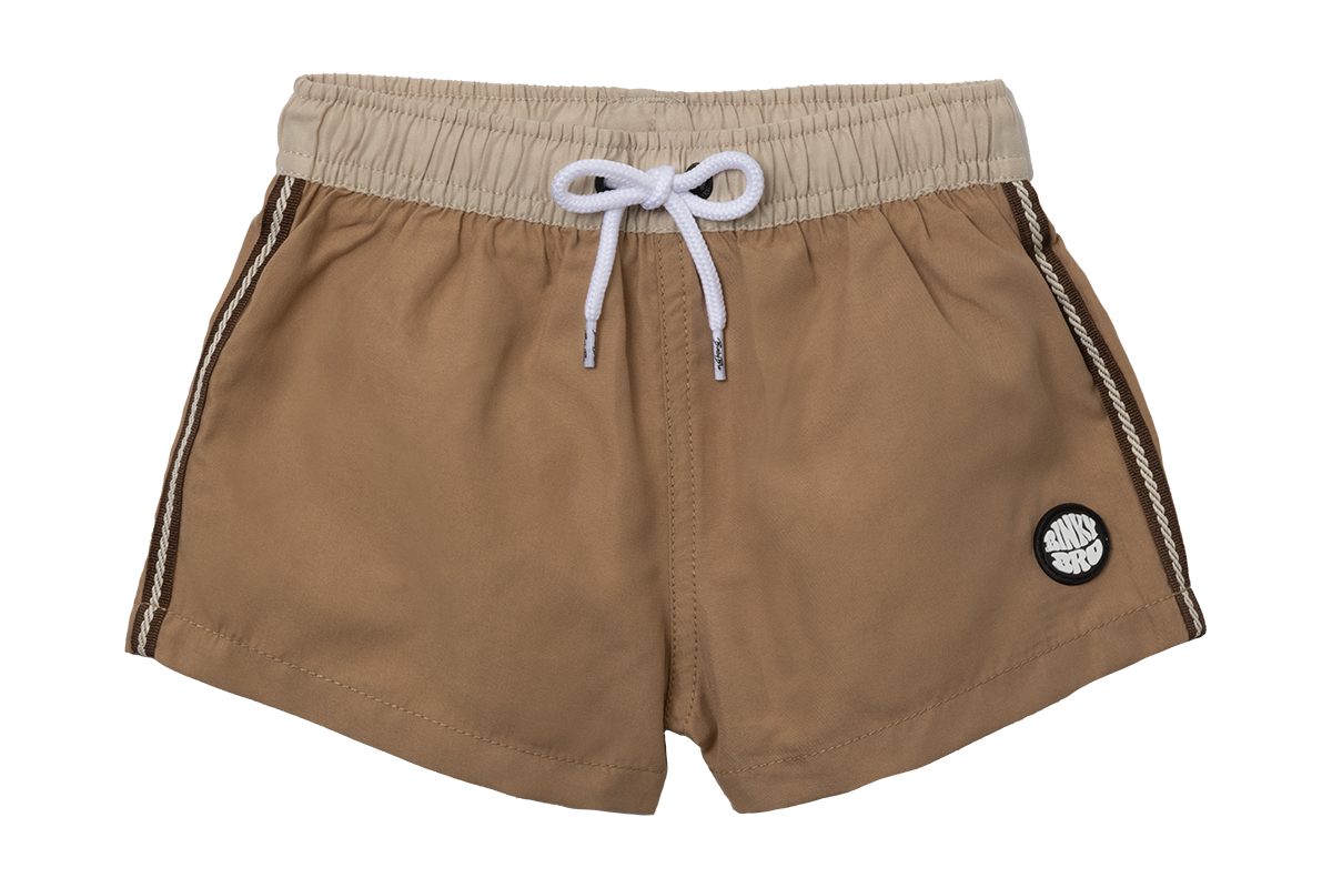 Stylish brown swim shorts for kids with an elastic waistband and drawstring, featuring a logo patch on the side.