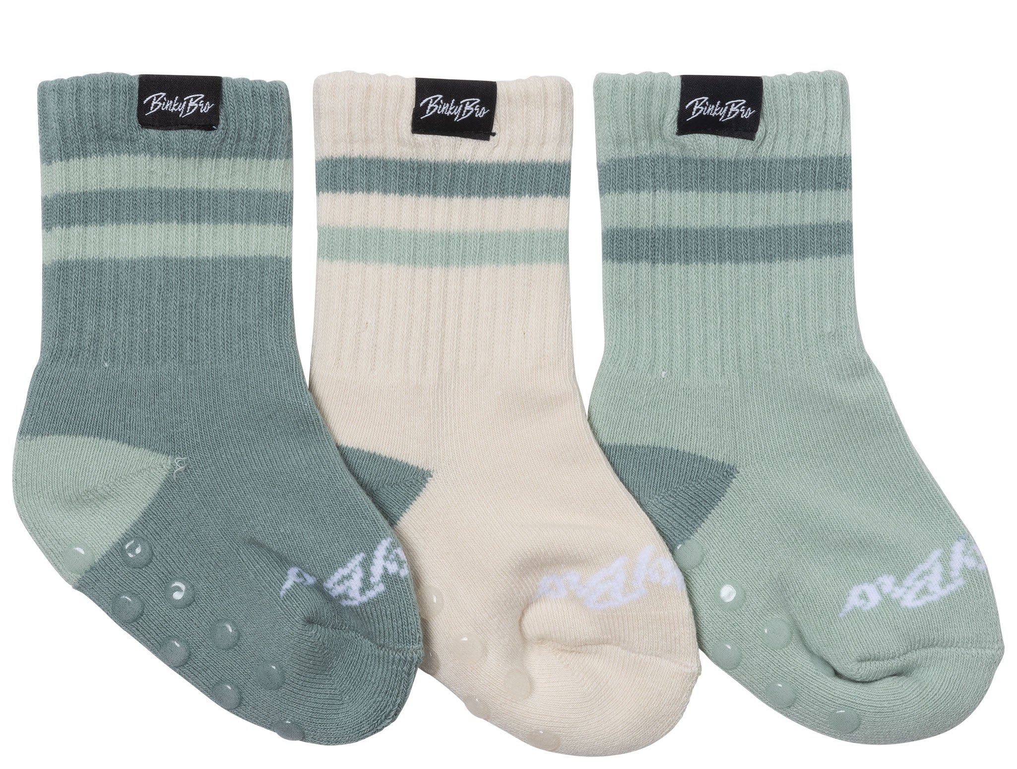 Three pairs of teal and neutral socks featuring different patterns and non-slip grips, perfect for kids' active wear.