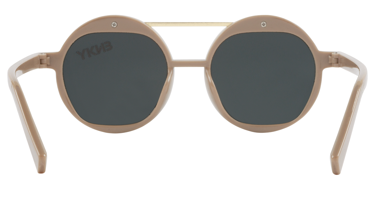 Stylish round sunglasses in a soft beige frame with dark lenses, perfect for kids' outdoor adventures.