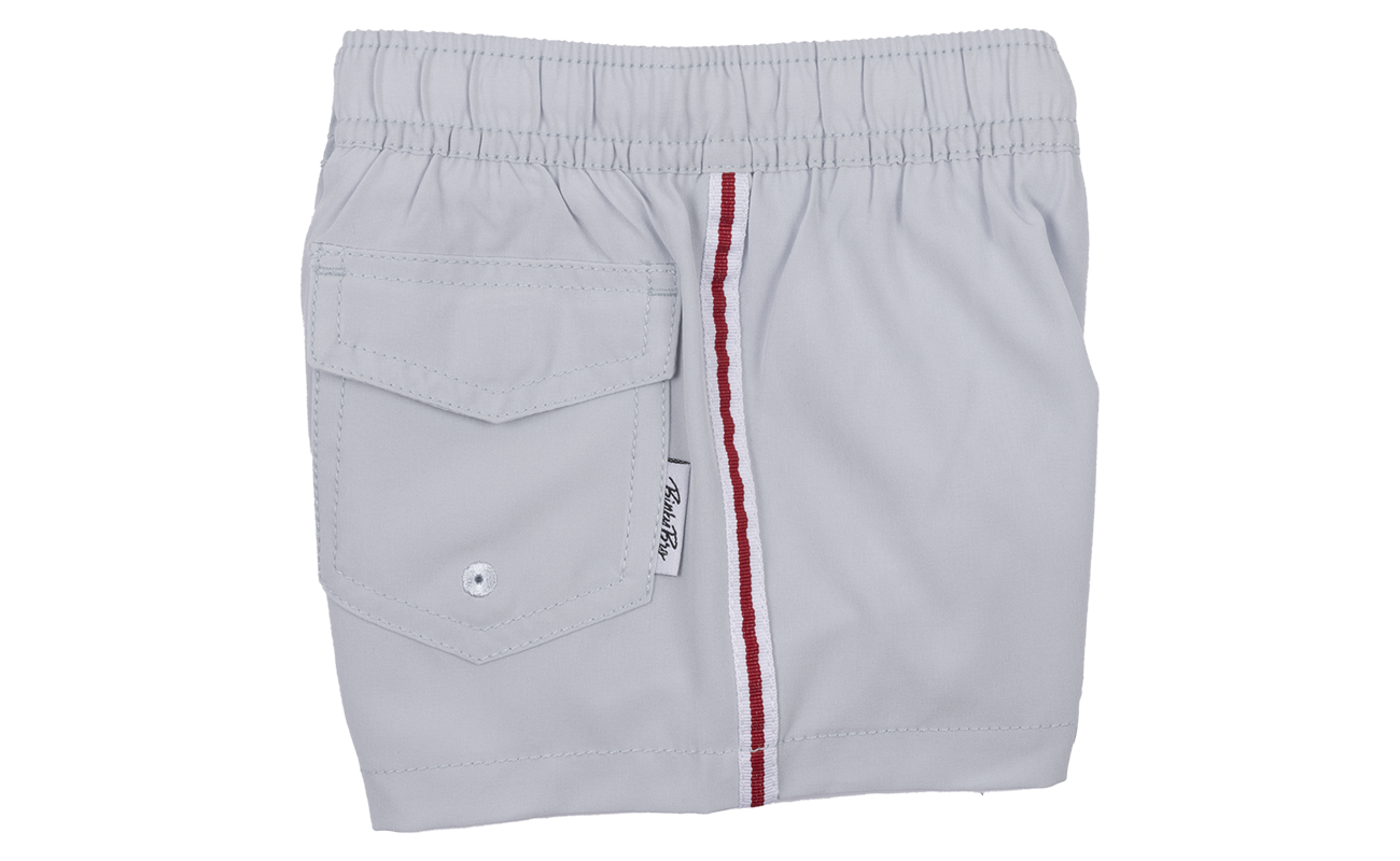 Light gray swim shorts for kids featuring a side pocket and red stitching, perfect for beach and pool days.