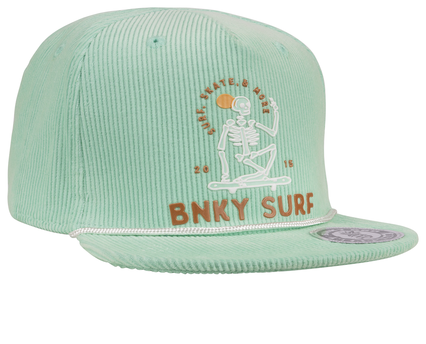 Mint green snapback hat featuring a skeleton graphic and "BNKY SURF" embroidery, perfect for kids' surf and skate style.