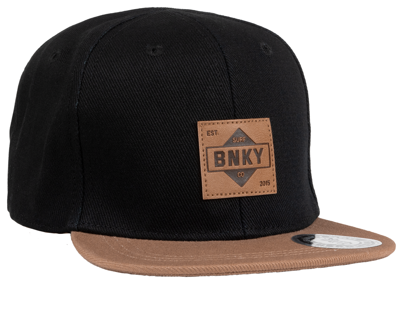 Stylish black snapback hat with a tan brim and leather patch featuring BNKY logo, perfect for kids' surf and skate lifestyle.