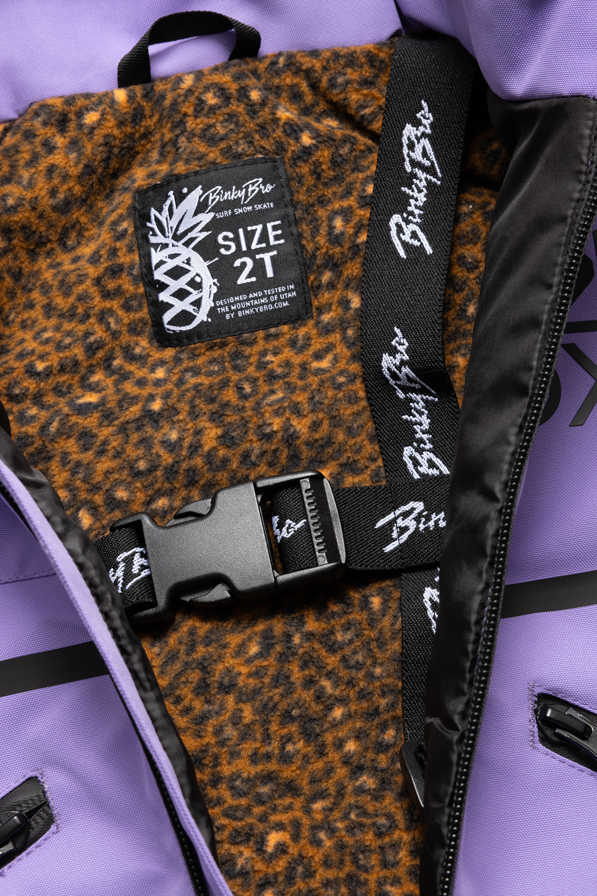 Interior view of a purple Roxy jacket featuring a leopard print lining and a size tag for 2T.