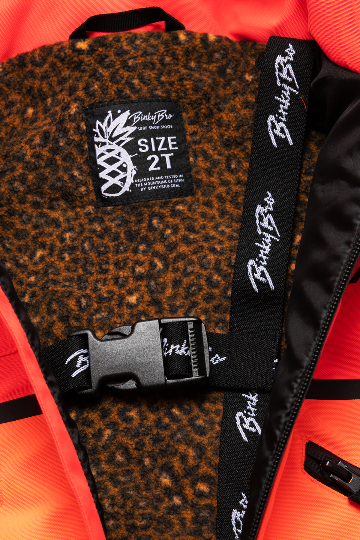 Interior view of the 99-90 Roxy Fire jacket featuring a leopard print lining and a size tag for 2T.