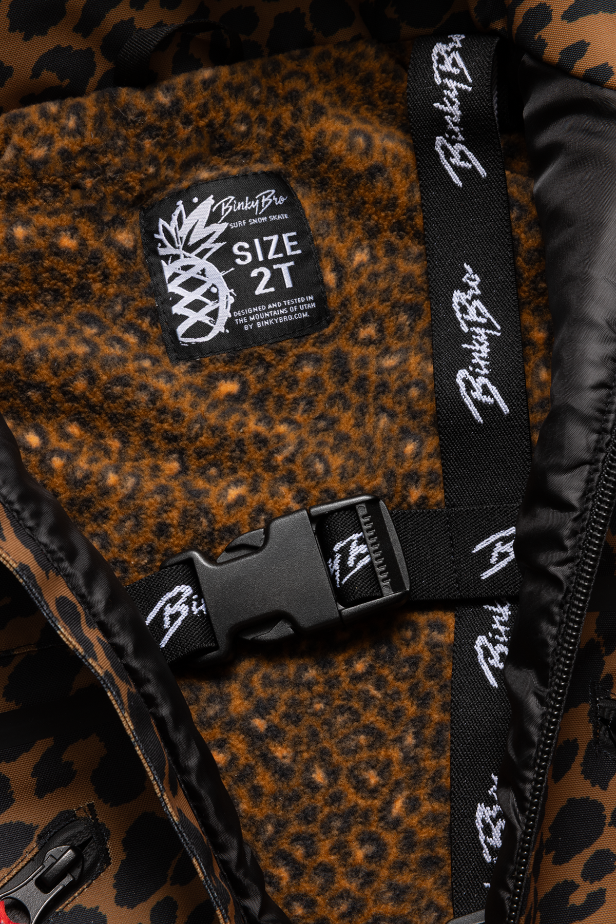 Interior view of the 99-90 Roxy Cheetah jacket featuring a cheetah print lining and BinkyBro label, size 2T.