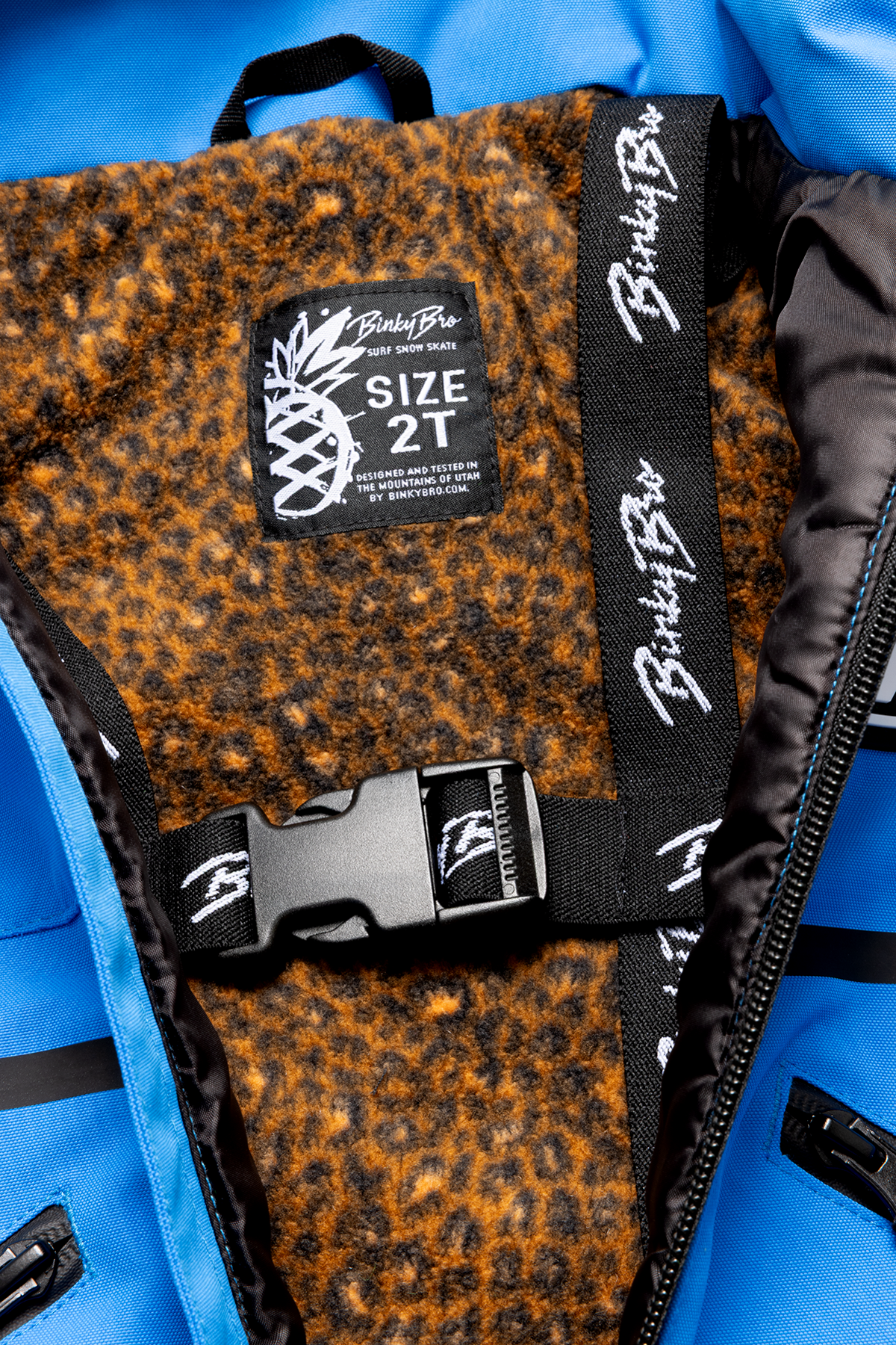 Interior view of the 99-90 BNKY Cobalt jacket showing a cozy leopard print lining and size tag for 2T.