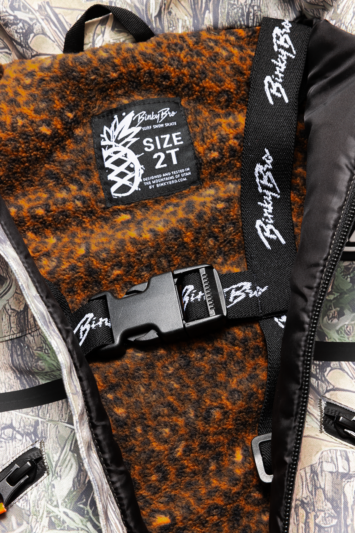 Interior view of the 99-90 BNKY Camo, featuring a soft lining, adjustable straps, and a size tag for toddlers.