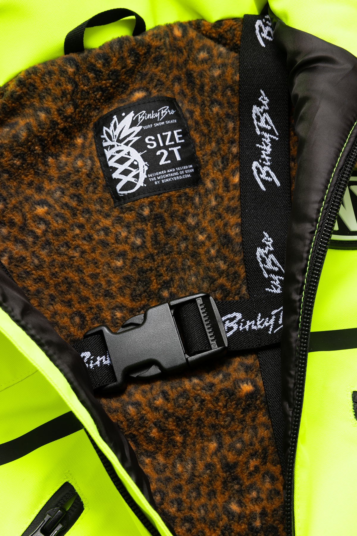 Interior view of the 99-90 BNKY Chartreuse jacket featuring a leopard print lining and a size tag for 2T.
