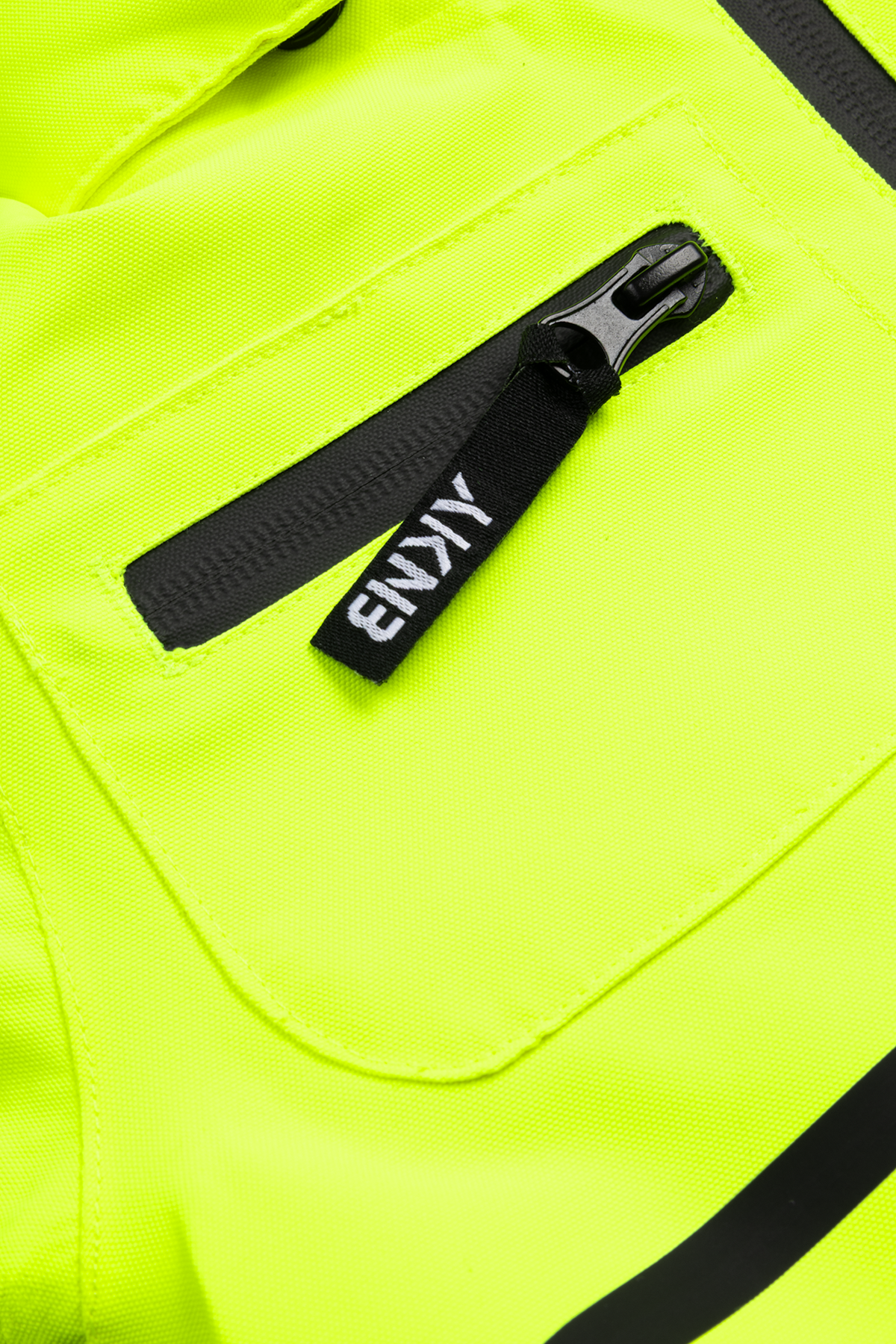 Close-up of a bright chartreuse jacket featuring a zippered pocket and a black zipper pull, showcasing a stylish design for kids.