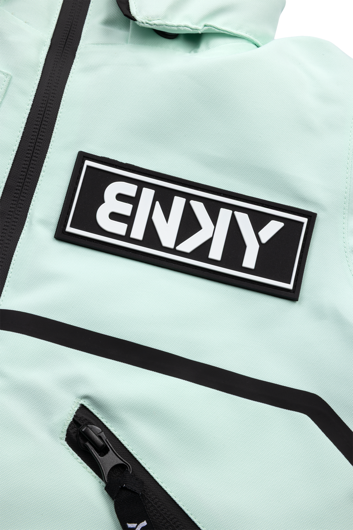 Dusty teal jacket featuring a bold black BNKY logo patch and zippered pockets, perfect for stylish outdoor adventures.