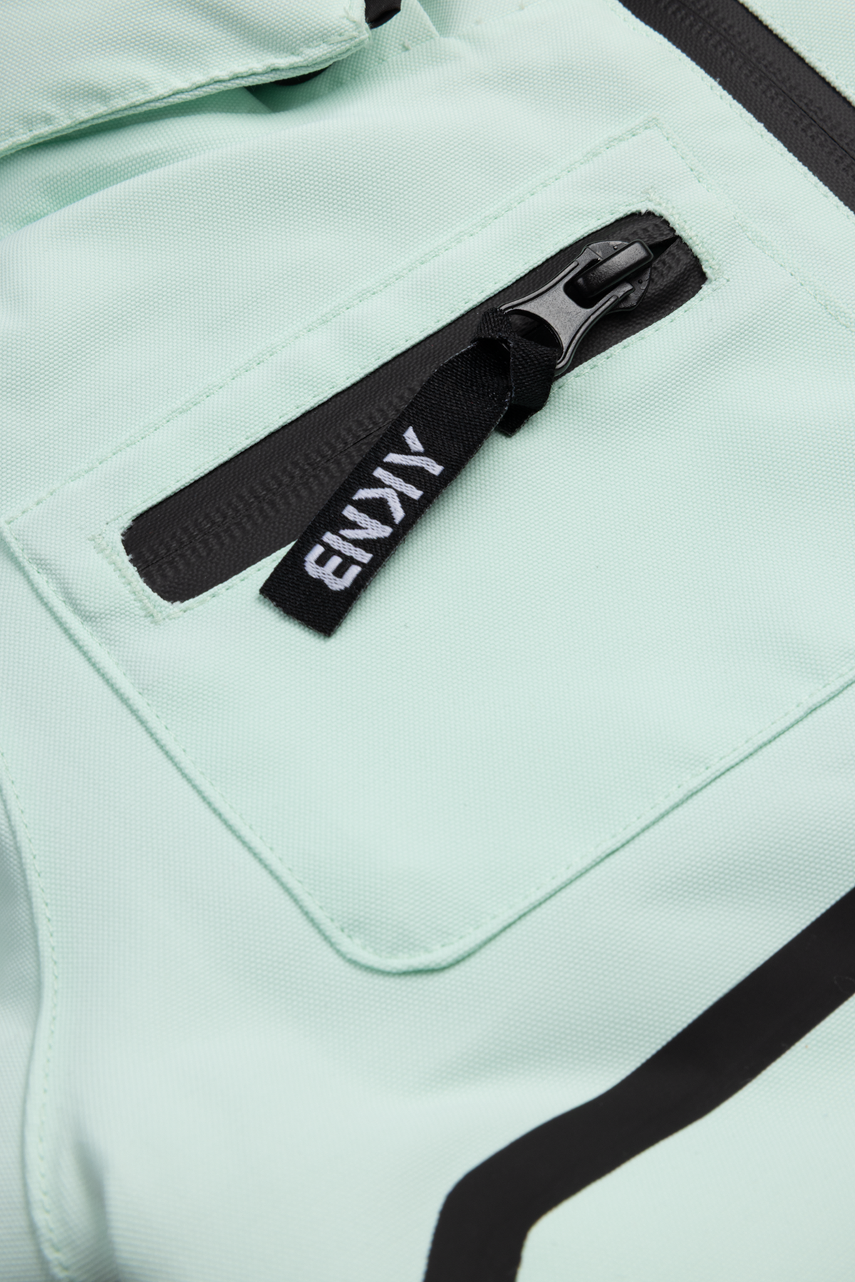 Dusty teal backpack featuring a zippered pocket and branded zipper pull, designed for stylish kids' outdoor adventures.