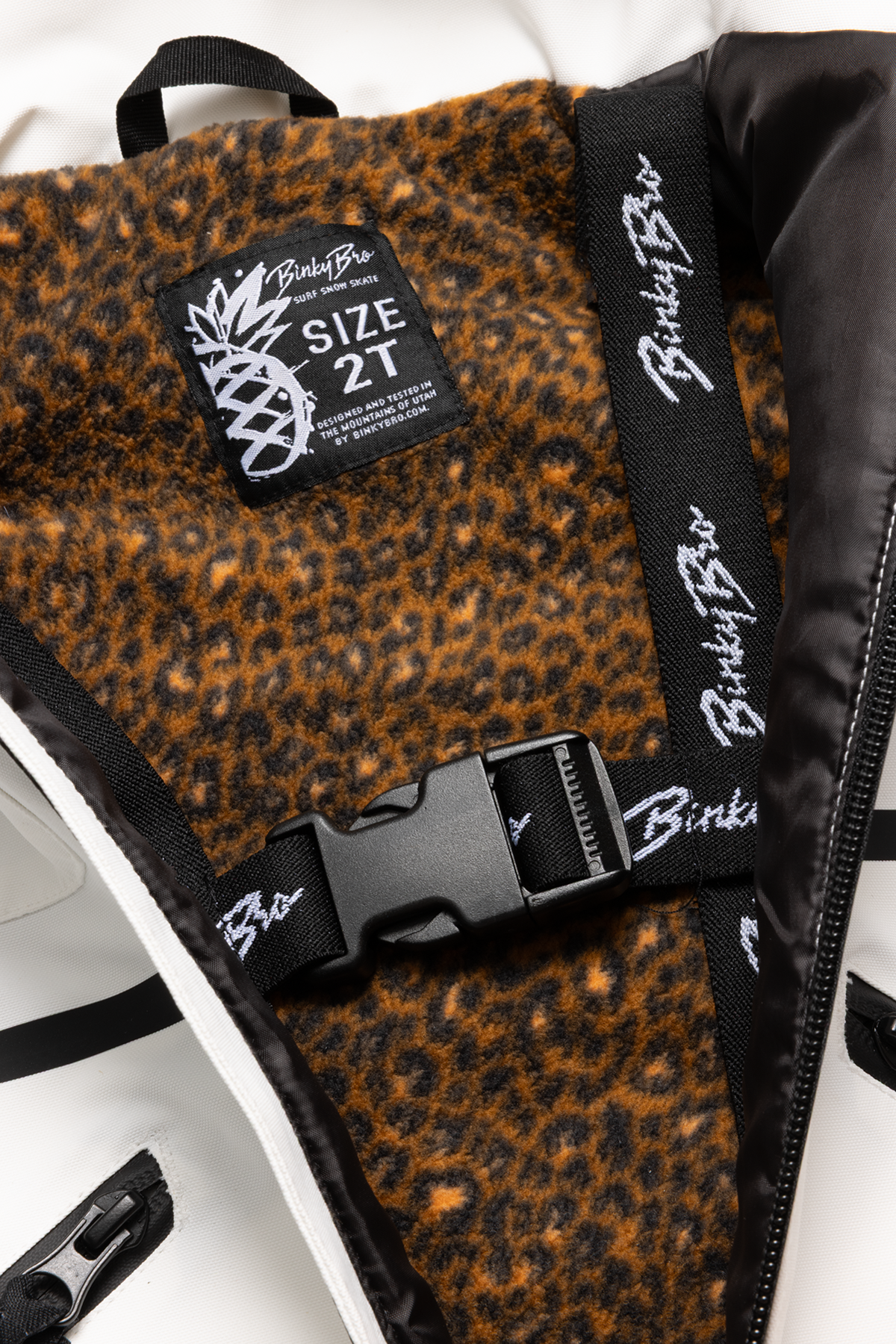 Interior view of the 99-90 BNKY Stalactite jacket featuring a leopard print lining and branded straps, designed for toddlers.