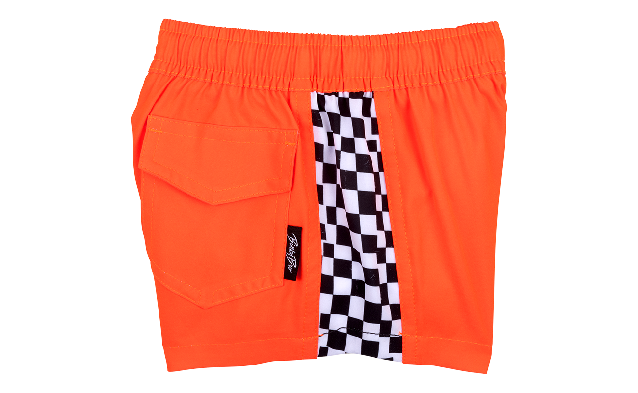 Bright orange shorts featuring a checkered side panel and a side pocket, perfect for active kids. Ideal for summer adventures.