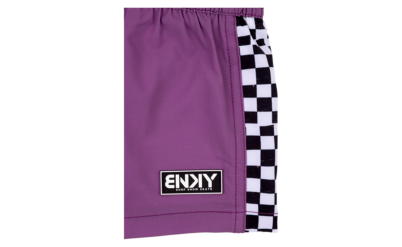 Purple swim shorts featuring a checkered side panel and a stylish logo, perfect for kids embracing a surf-snow-skate lifestyle.