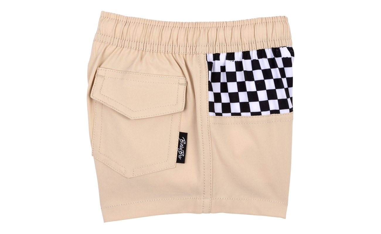 Beige toddler shorts featuring a checkered pocket and elastic waistband for comfort and style. Perfect for active kids.