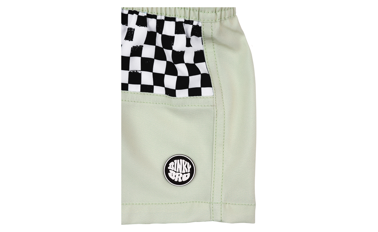 Light green shorts featuring a black and white checkered pocket and a BinkyBro logo, perfect for active kids.