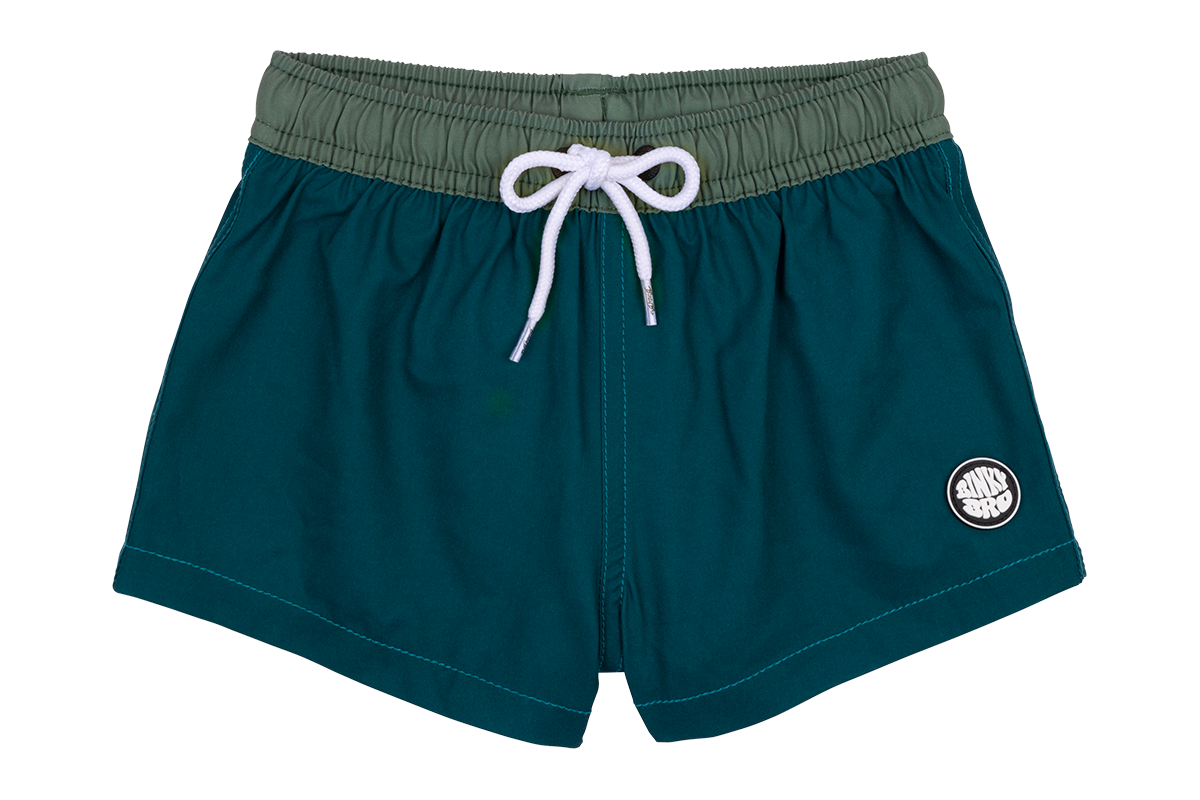 Teal swim shorts with an elastic waistband and white drawstring, featuring a circular logo on the lower left side.