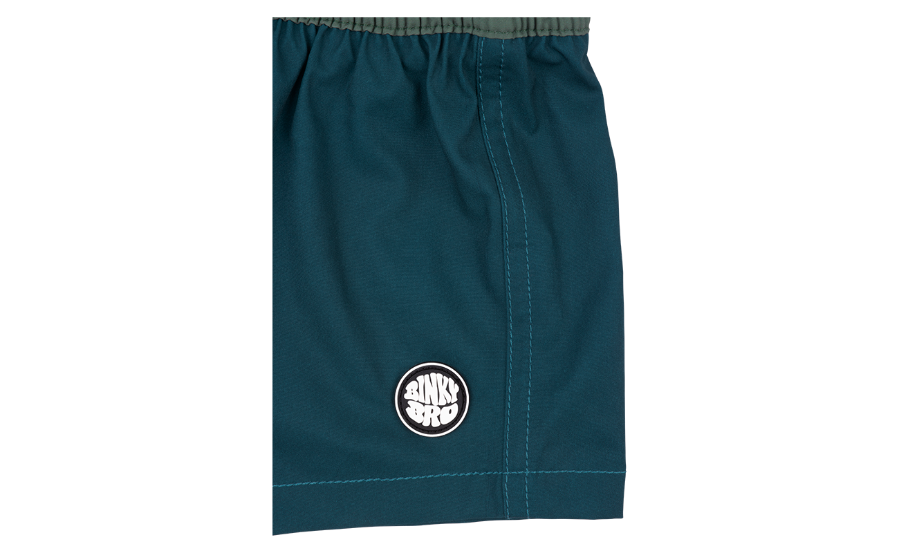 Stylish teal shorts featuring a circular BinkyBro logo, designed for active infants and toddlers. Perfect for outdoor play.