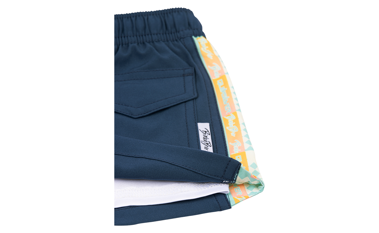 Stylish navy shorts with a colorful patterned trim, designed for kids, perfect for surf and skate adventures.