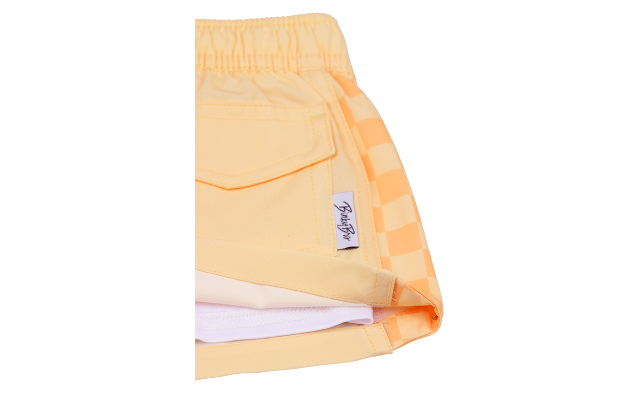 Peach BB x Quik Checkers shorts featuring a stylish checkered design and comfortable waistband for kids.