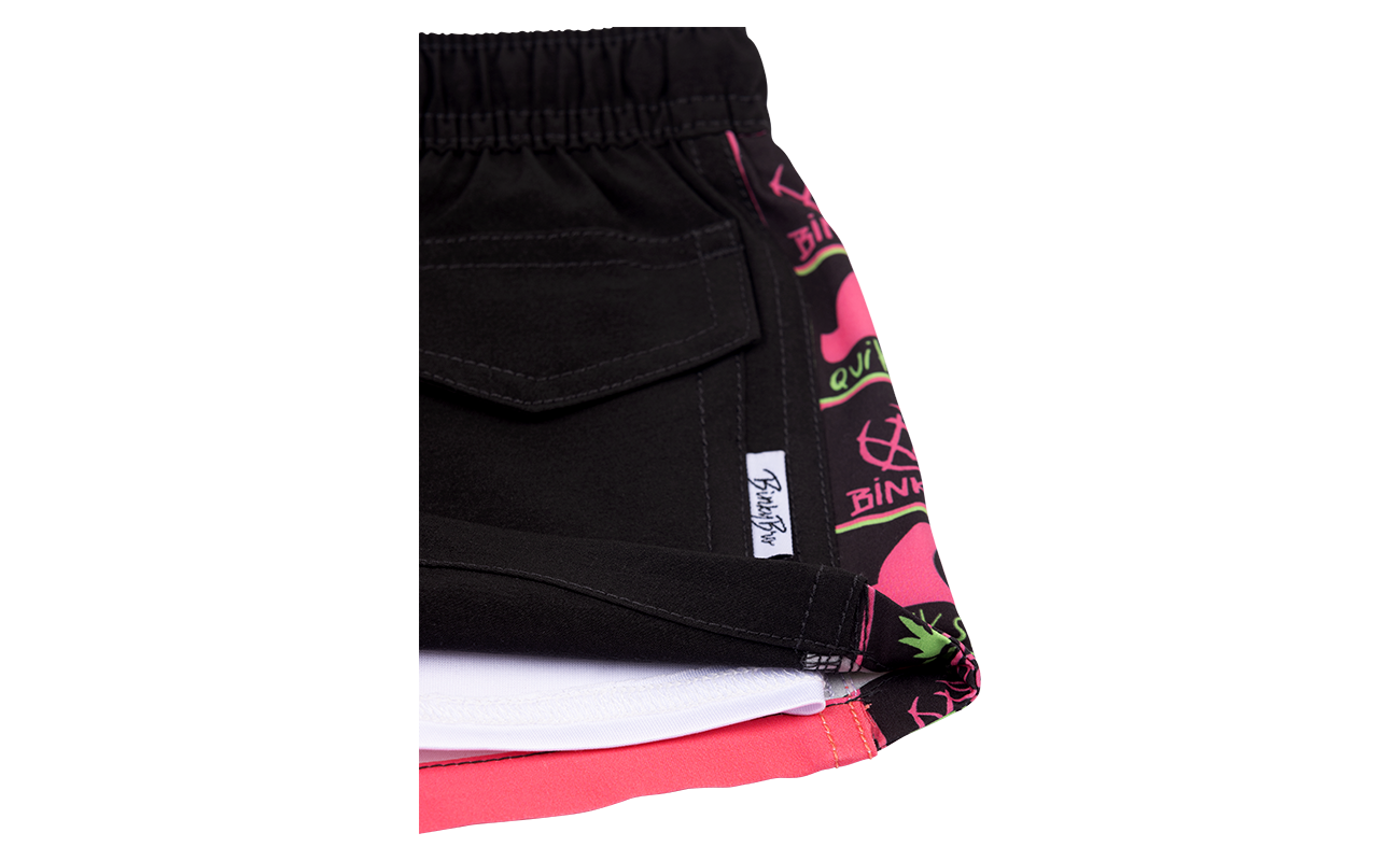 Stylish BB x Quik Siargo swim shorts featuring a black exterior and vibrant pink patterned lining, perfect for active youth.