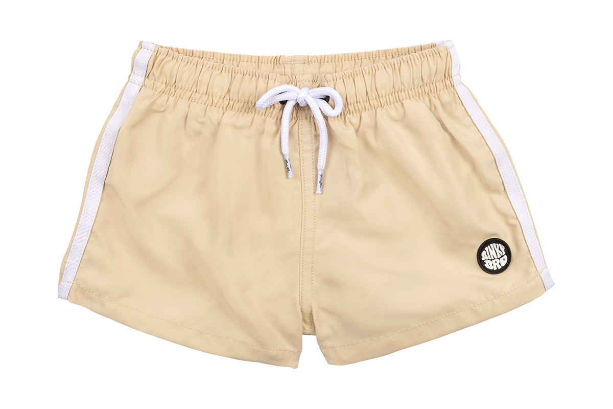 Stylish beige swim shorts with white side stripes and a logo, perfect for kids' beach and pool adventures.