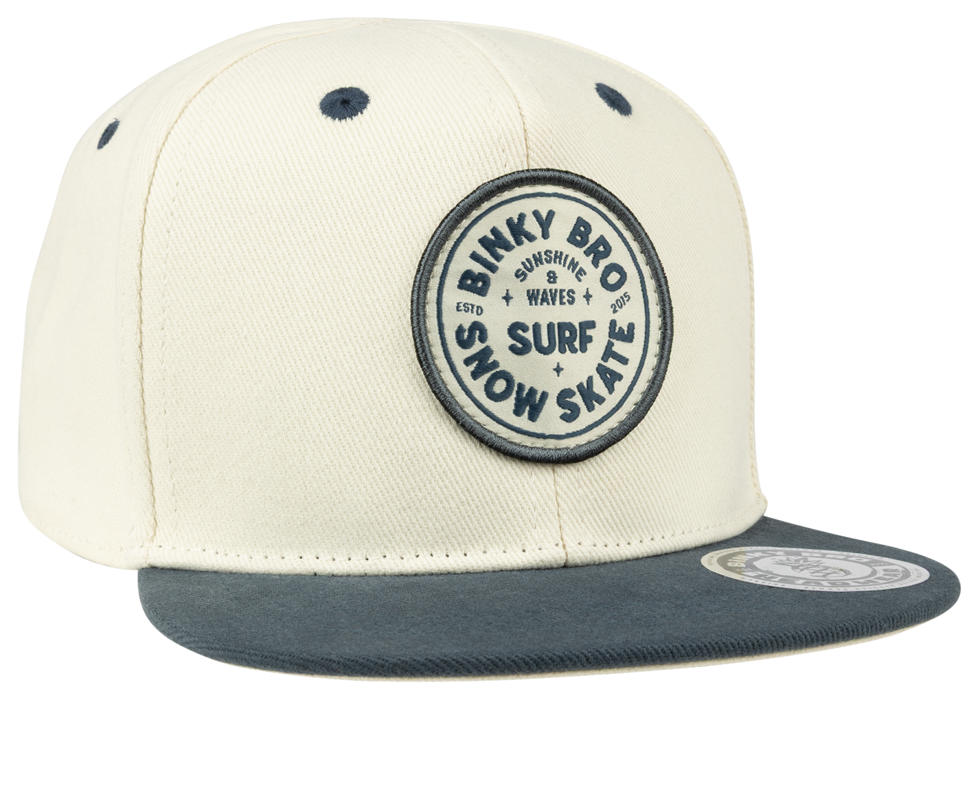Stylish cream snapback hat with navy brim and Binky Bro surf-snow-skate logo, perfect for kids' outdoor adventures.