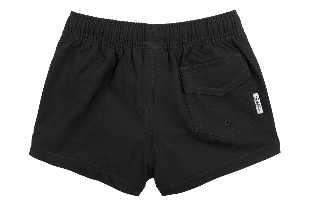 Black swim shorts for kids featuring an elastic waistband and a back pocket, designed for stylish beach or pool outings.