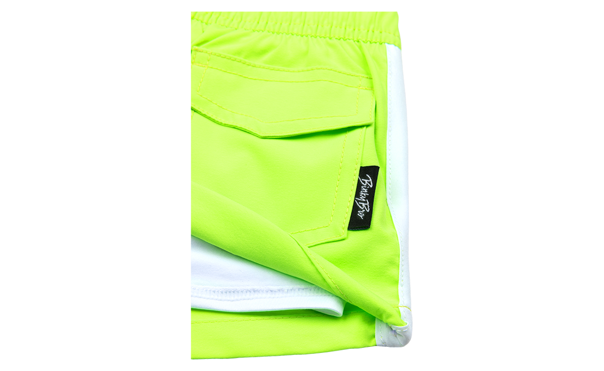 Bright neon green shorts with a white trim and a small BinkyBro label on the pocket, designed for active kids.
