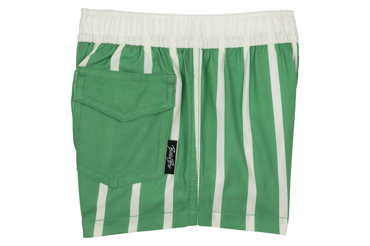Green and white striped swim shorts with an elastic waistband and a back pocket, designed for kids' surf-snow-skate style.