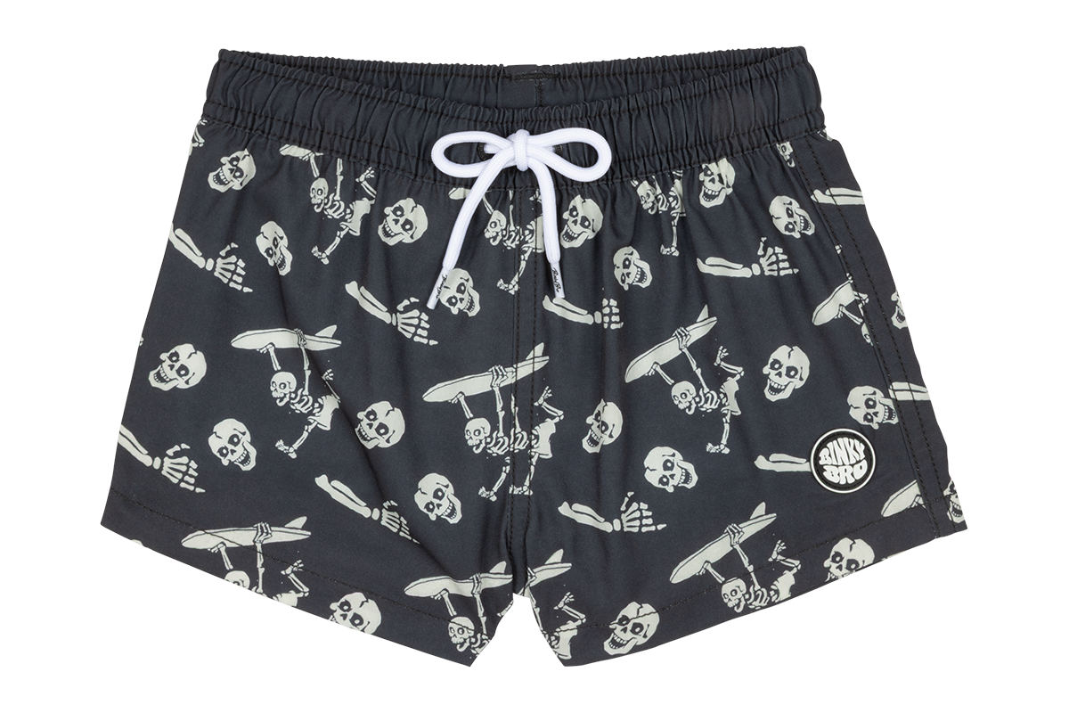 Stylish black swim trunks featuring a playful skeleton print, perfect for kids who love surf and skate culture.
