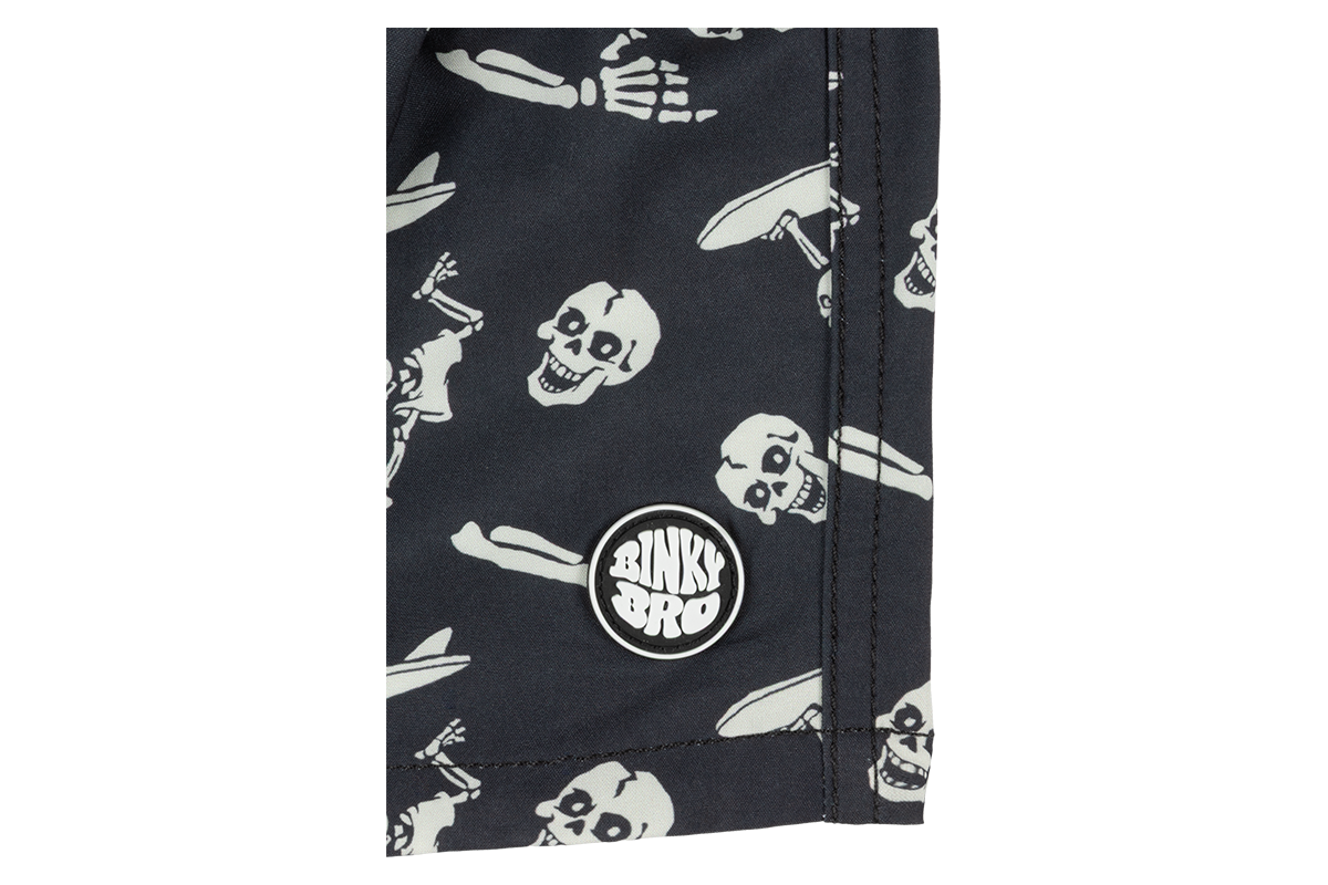 Stylish black fabric featuring a playful skull and crossbones pattern, showcasing BinkyBro's unique design for kids.
