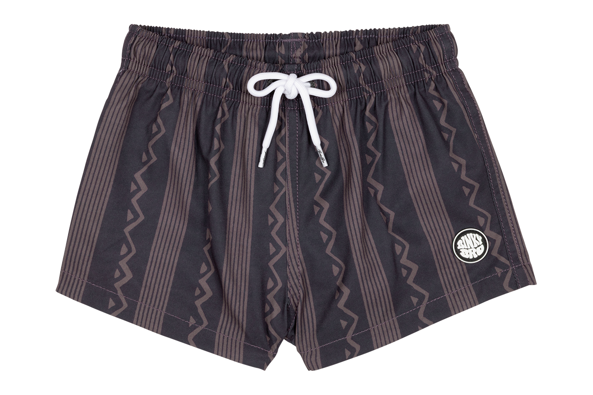 Stylish black swim shorts with a zigzag pattern and white drawstring, perfect for kids' summer adventures.
