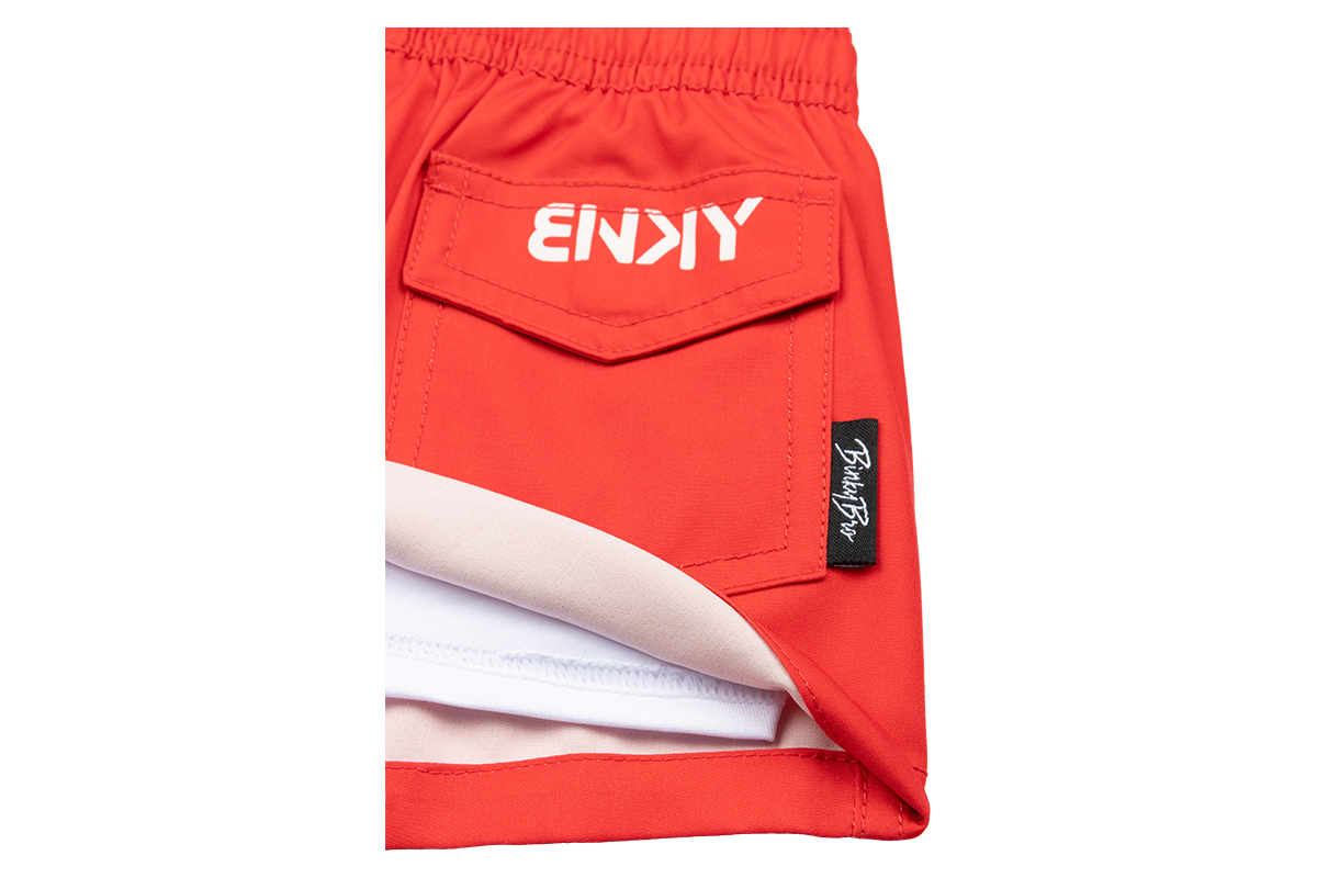 Stylish red shorts featuring a pocket design and BinkyBro logo, perfect for active infants and toddlers.