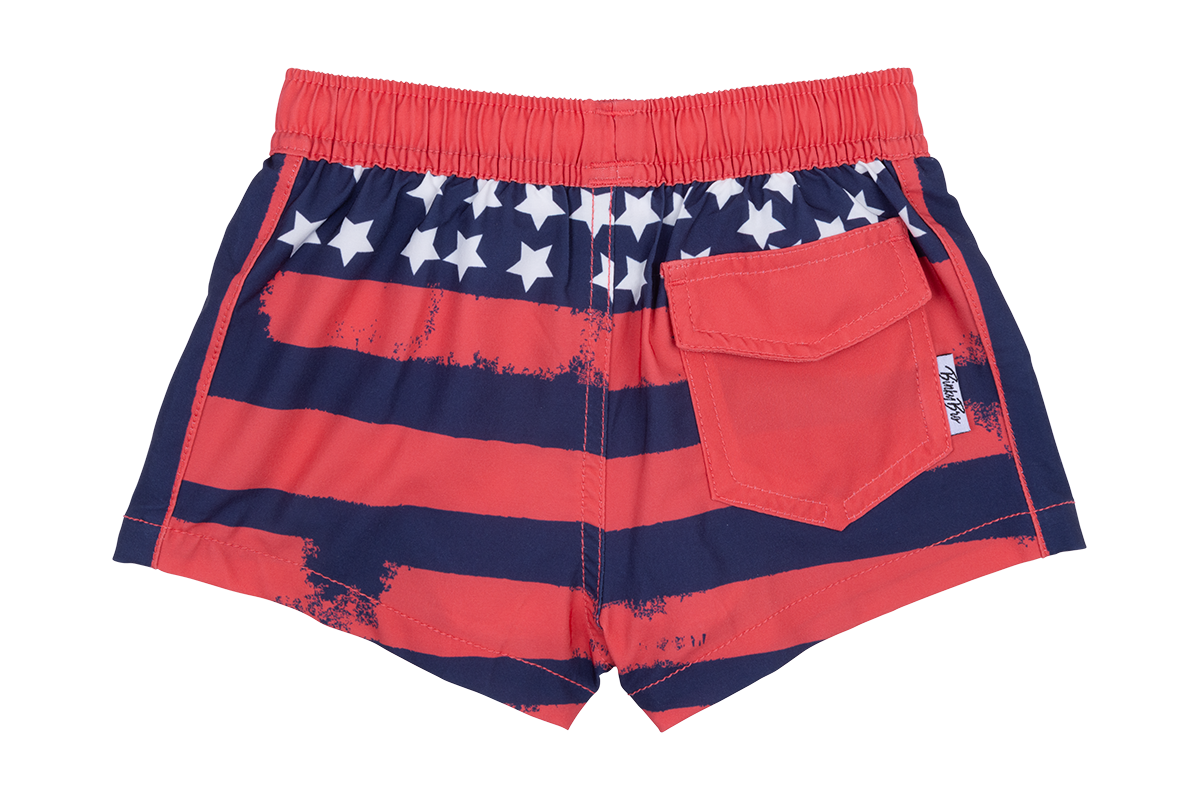 Red swim shorts featuring a distressed American flag design with white stars and a back pocket. Ideal for summer fun.