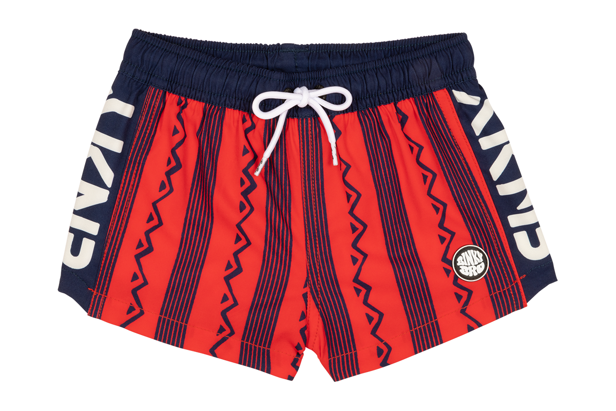 Stylish crimson swim trunks featuring a bold geometric pattern and contrasting navy accents, perfect for active youth.