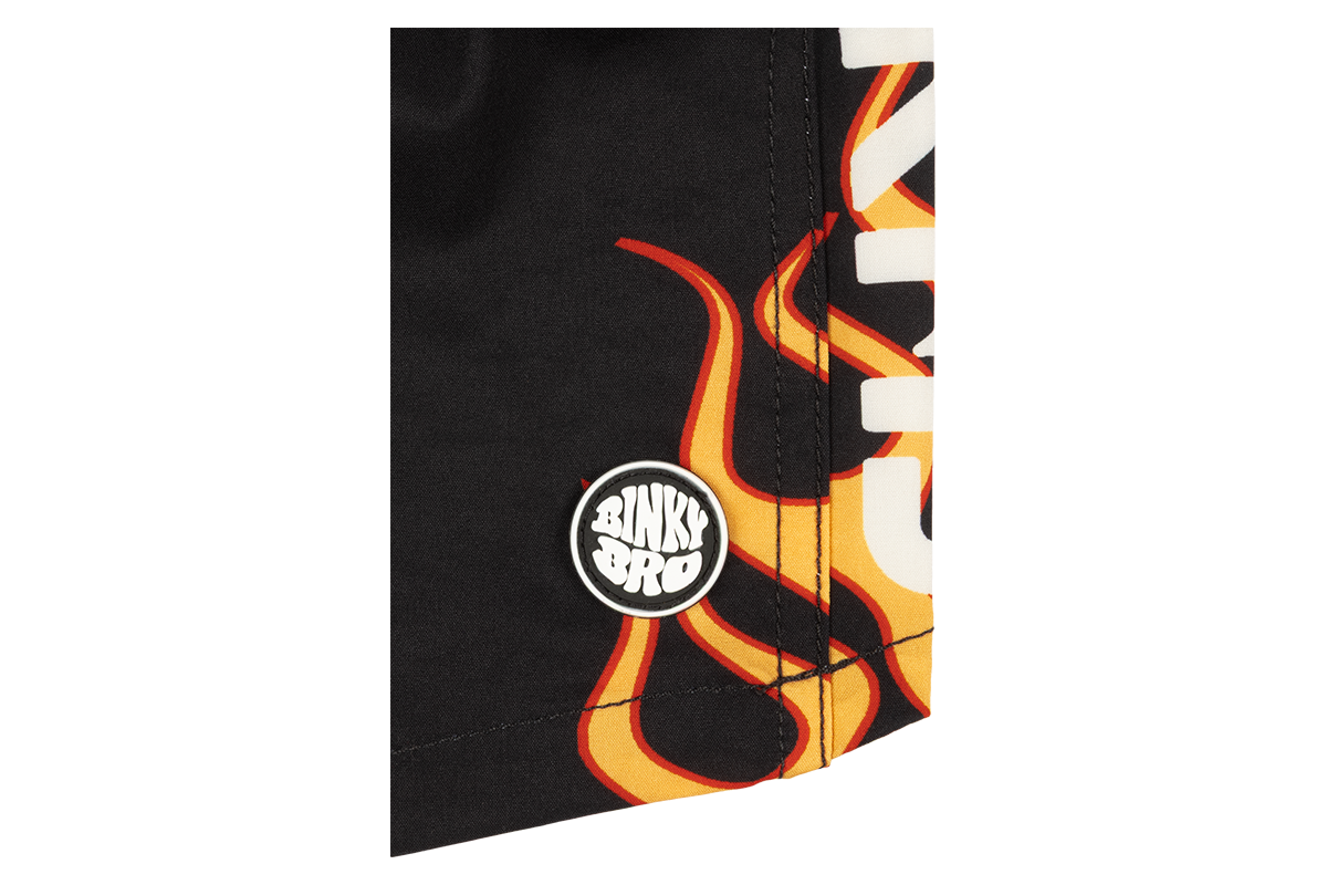 Close-up of a black fabric featuring bold stamped flame graphics and the BinkyBro logo, ideal for stylish kids' apparel.