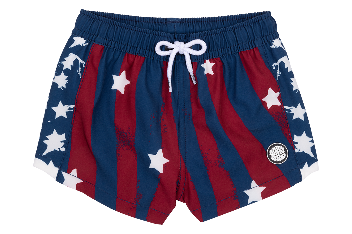 Red and blue swim shorts featuring white stars and stripes, perfect for a stylish summer look. Ideal for kids.