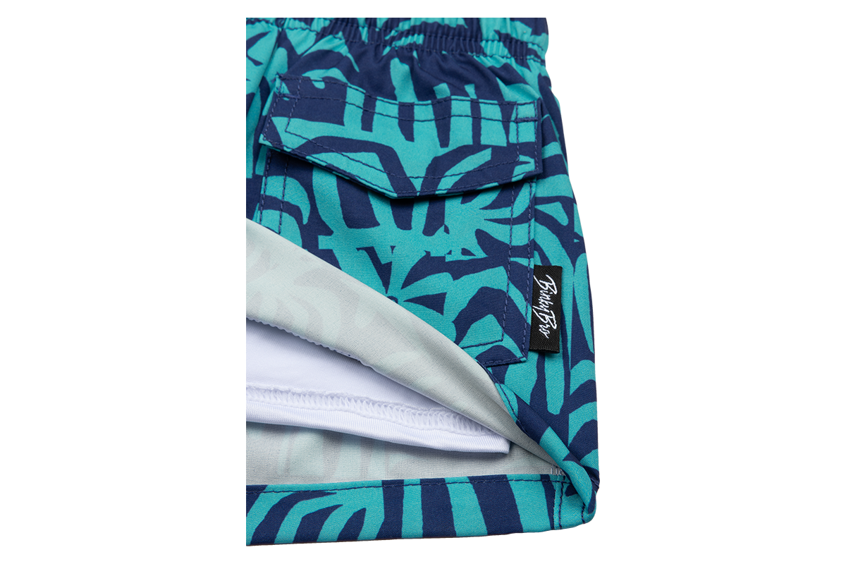 Stylish Tahitian swim trunks featuring a vibrant blue and green tropical pattern, perfect for kids' summer adventures.
