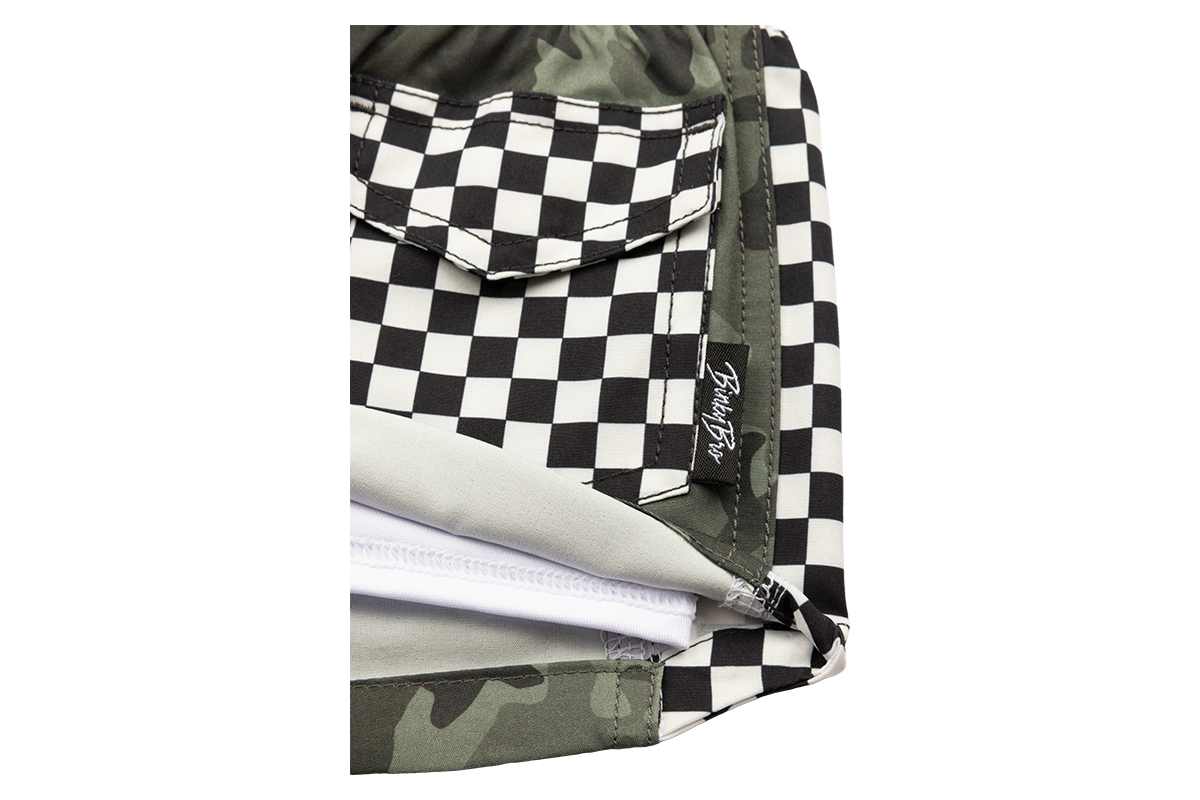 Stylish snapback featuring a black and white checkerboard pattern with a camouflage accent, perfect for kids.