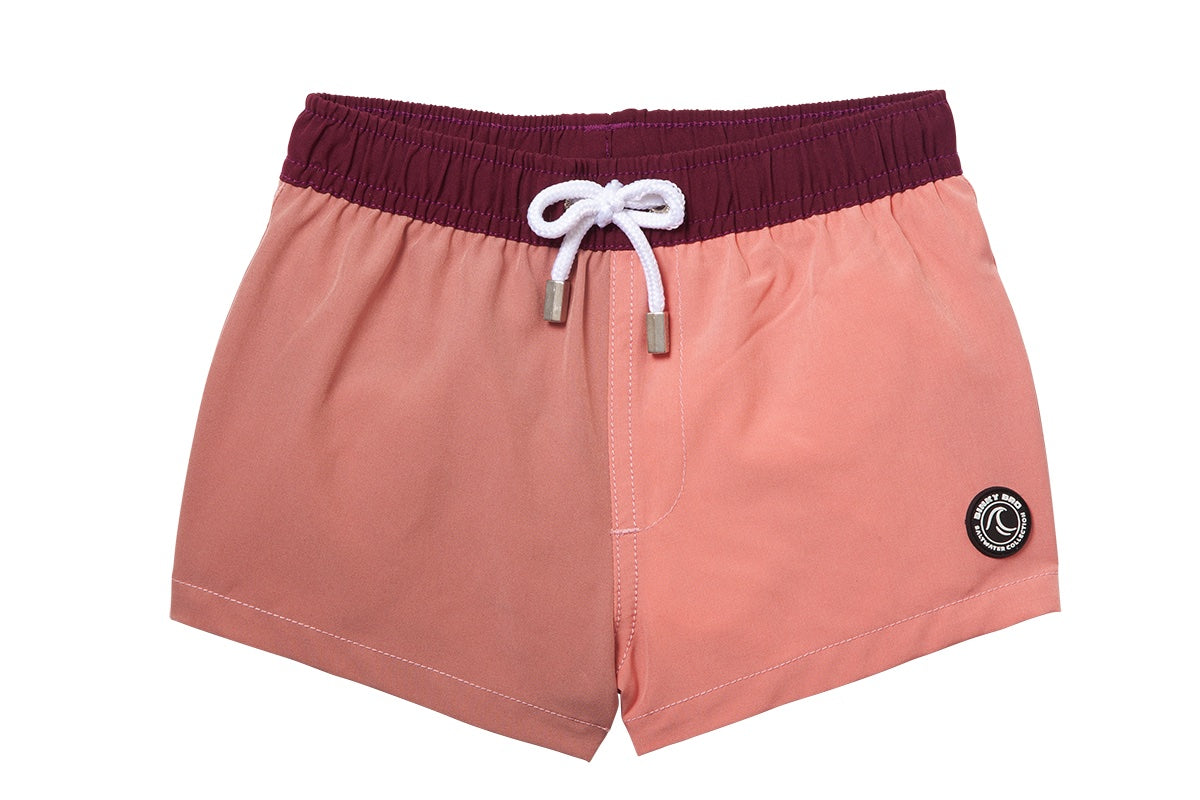 Stylish two-tone swim shorts for kids featuring a comfortable elastic waistband and drawstring, perfect for beach days.