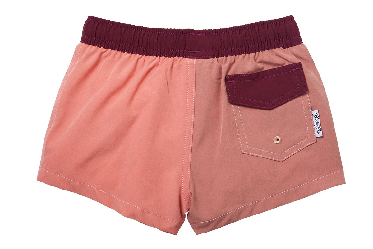 Stylish two-tone swim shorts for kids featuring an elastic waistband and a back pocket, perfect for beach adventures.