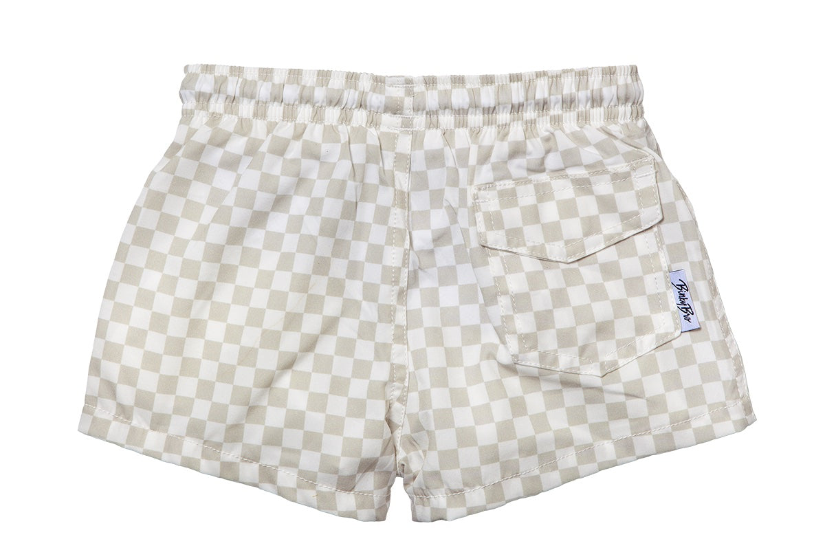Beige checkered swim shorts with an elastic waistband and a back pocket, designed for infants and toddlers.