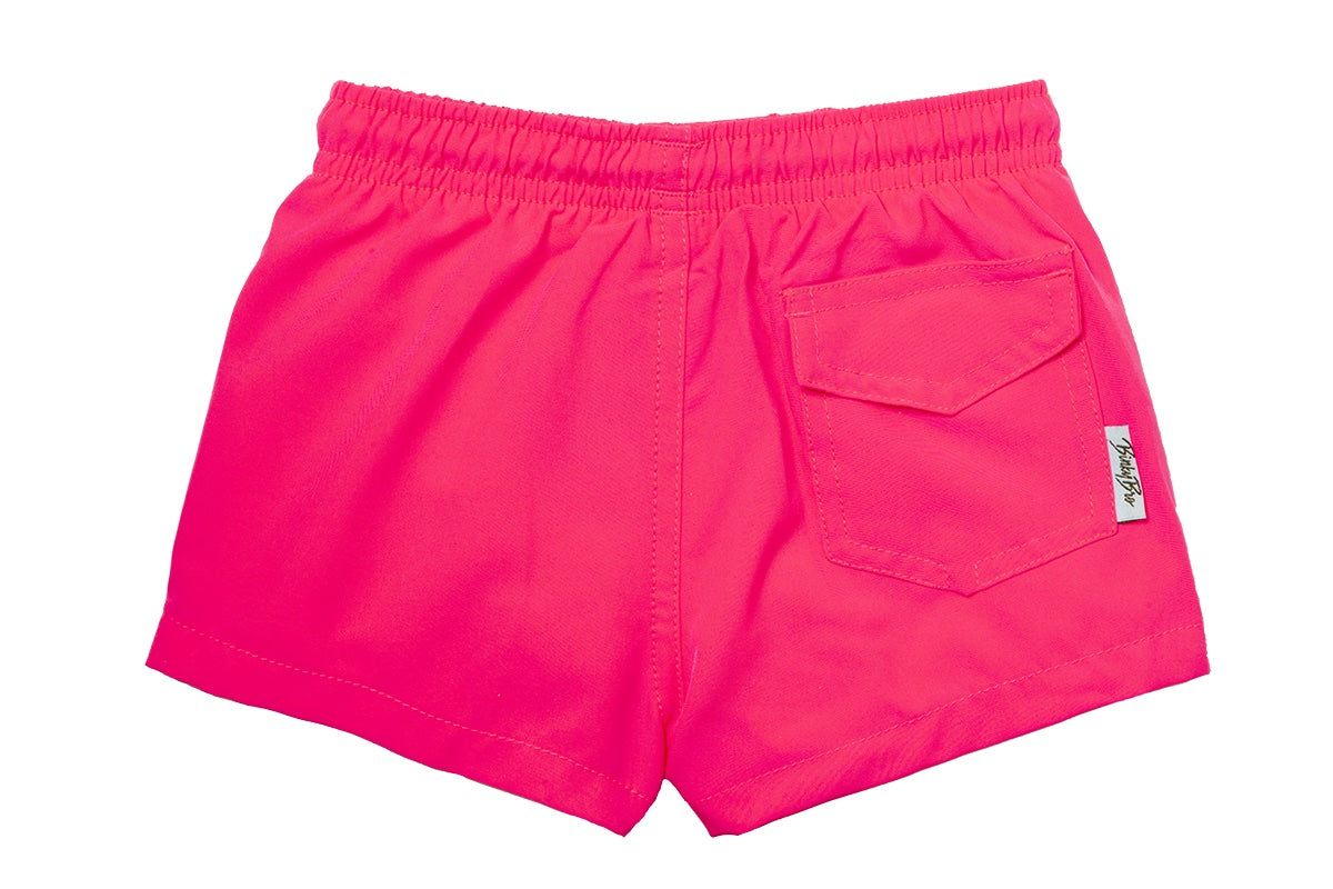 Bright pink swim shorts for kids featuring an elastic waistband and a back pocket, perfect for summer fun.