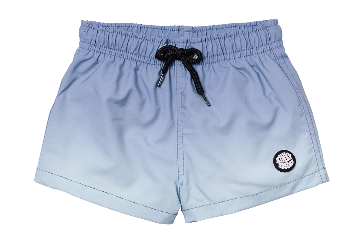 Indigo gradient swim shorts with an elastic waistband and black drawstring, featuring a logo patch on the side.