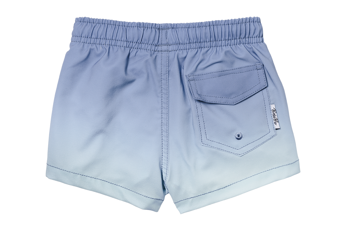 Indigo gradient swim shorts for kids featuring an elastic waistband and a back pocket for a stylish beach look.
