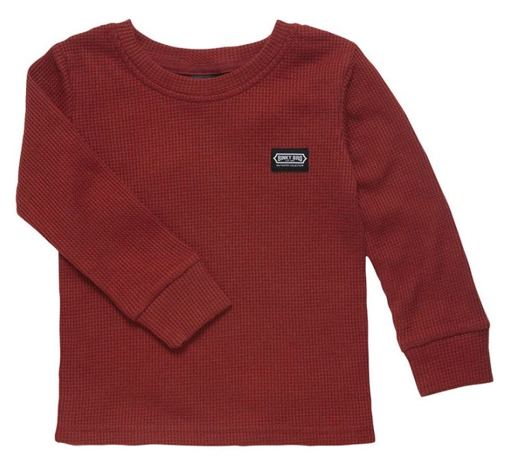 Maroon long-sleeve shirt for kids with a textured fabric and a small brand label on the chest. Ideal for stylish layering.