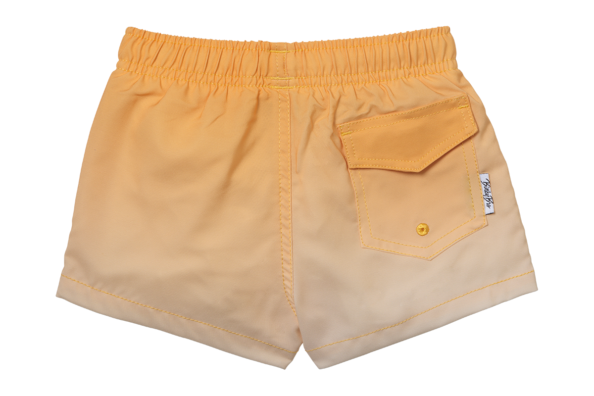 Light orange swim shorts for kids with an elastic waistband and a back pocket, perfect for beach or pool days.