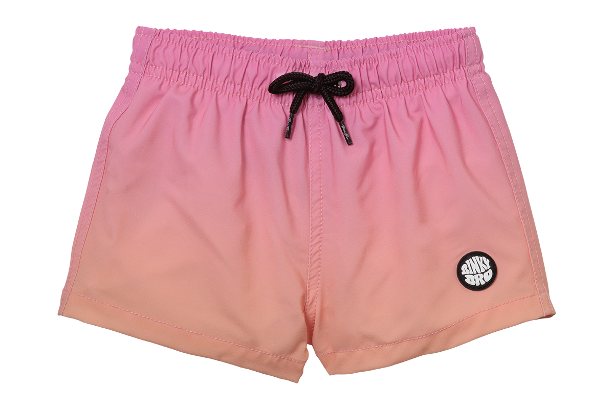 Pink gradient swim shorts with a black drawstring and logo, designed for infants and toddlers.